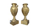 two gold vases sitting on top of each other
