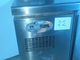 a stainless steel counter top freezer in the corner of a room