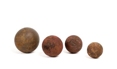 a group of three rusty metal balls sitting next to each other