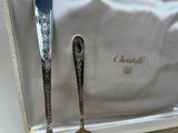 a silver spoon and a silver spoon sitting next to each other