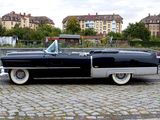 a black and silver car parked on a brick road