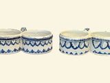 three blue and white ceramic containers with lids on a white background
