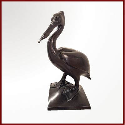 une statue en bronze représentant un pélican posé sur un socle