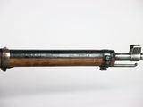a close up of a rifle with a wooden handle on a white background