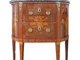 a small chest of drawers with a marble top