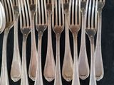 a lot of forks and spoons that are on a table