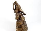 brass figurine of a woman with a bird on her head