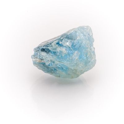 an image of a rough blue diamond on a white surface