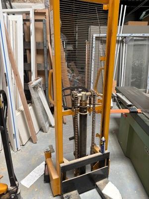 a fork lifter that is sitting in the middle of a room