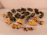 a lot of toy army vehicles on a white surface
