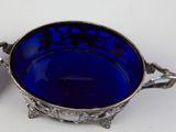 a small blue bowl with a spoon in it