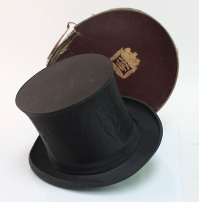 a black top hat sitting on top of a brown box