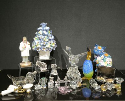 many glass figurines on display on a black table