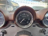 a close up of a dashboard with a clock and gauges