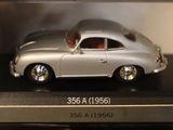 a silver toy car on display in a glass case