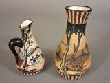 two vases sitting next to each other on a table