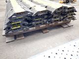 a pile of steel beams on a pallet in a warehouse