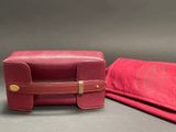 pair of red leather cases with monograms on them on a gray surface