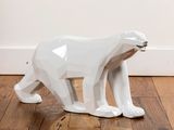 a white bear statue sitting on the floor in a room