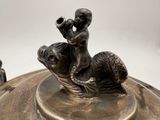 a bronze statue of a boy on a turtle