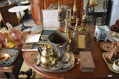 a table with a lot of antique items on it