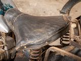 an old motorcycle that is sitting in a garage