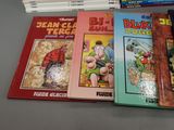 several children ' s books sitting on a table next to a stack of books