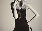 black and white photo of a woman in a short dress smoking a cigarette