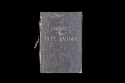an old book sitting on top of a black surface