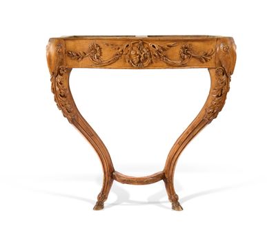 an ornately carved console table with a wooden top