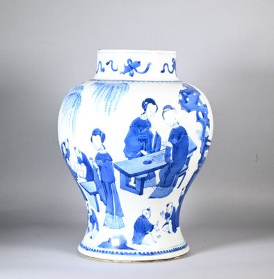 a blue and white vase with a picture of people sitting at a table