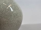 an old vase with a cracky surface sits on a white surface