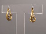 pair of gold tone earrings with clear crystal stones on clear acrylic stand