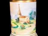 a vase with a painting of a church on it