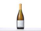 a bottle of white wine sitting on top of a table