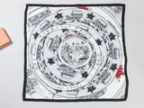 a black and white square scarf with a picture of a city on it