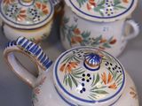 many different types of teapots and cups on the table
