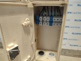 a white box with a bunch of electrical wires in it