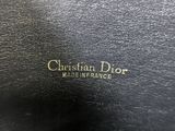 a close up of a black purse with a gold logo on it