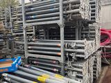 a large pile of steel pipes in a warehouse