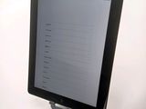 a tablet computer sitting on top of a white table