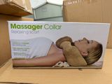 packaging of a massager collar sitting on a cardboard box on a table