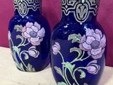two vases that have been painted with flowers on them