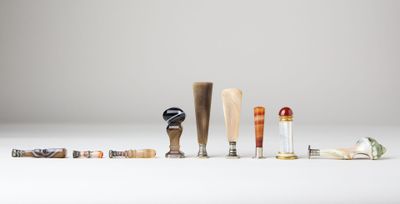 several different types of baseball bats are lined up on a white surface