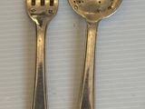 deux cuillères et une fourchette en argent sur une table