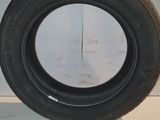 a close up of a tire on a white surface in a room