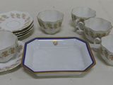 a lot of cups and saucers sitting on a table