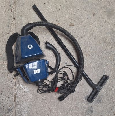a blue vacuum and a black hose on the ground