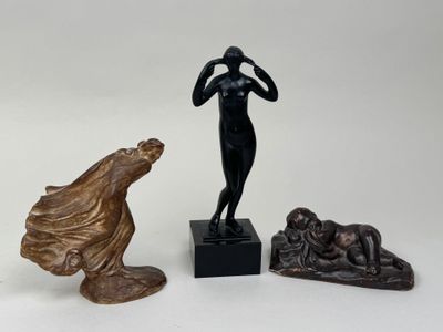 une statue représentant une femme debout à côté de deux autres statues