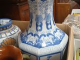 a blue and white vase sitting on top of a table